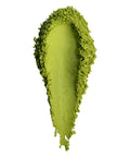 A textured smear of bright lime green cosmetic powder, likely eyeshadow or pigment, on a solid white background.