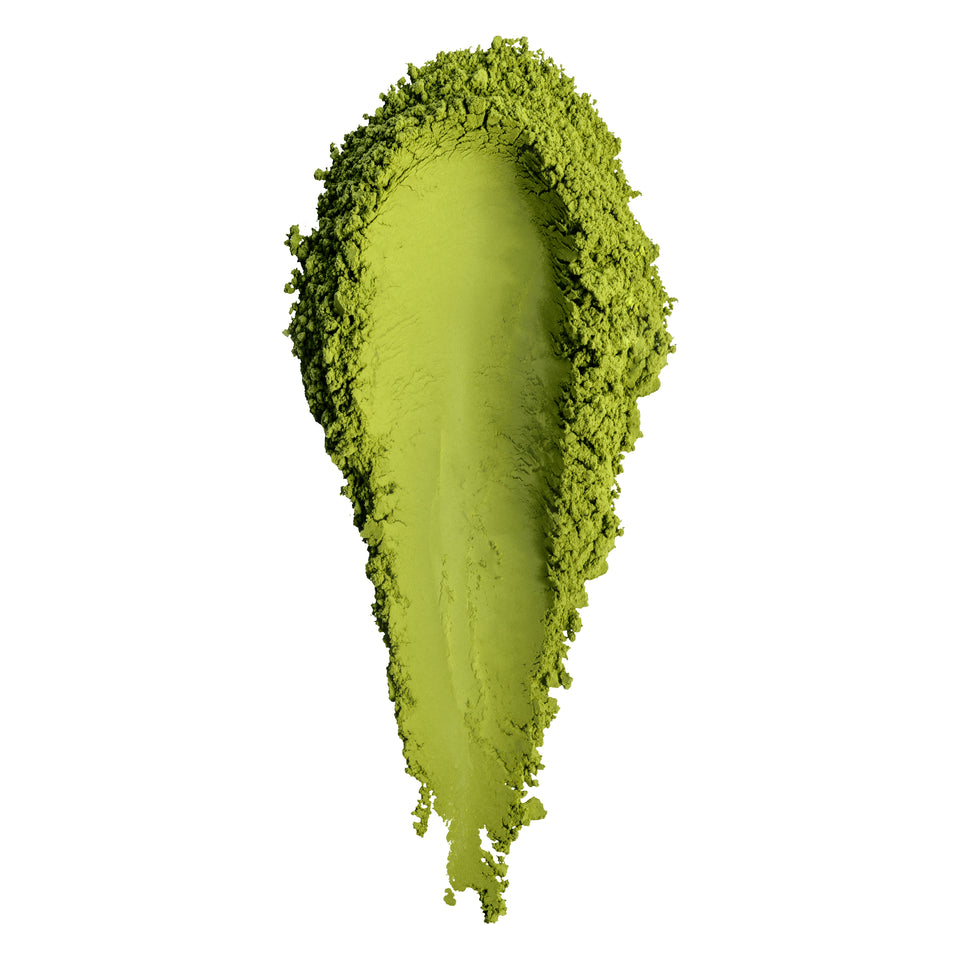 A textured smear of bright lime green cosmetic powder, likely eyeshadow or pigment, on a solid white background.