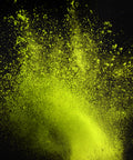 Vibrant lime green powder exploding in a dramatic spray against a solid black background.