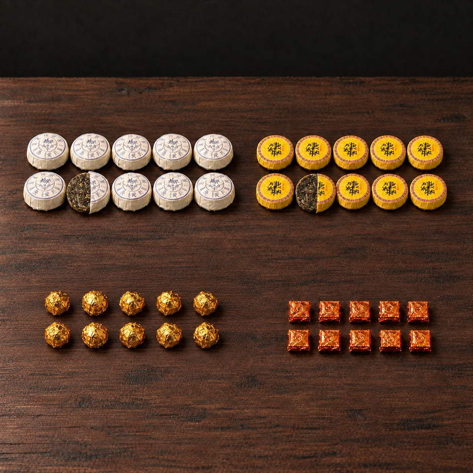 Pu-Erh Discovery Box: 10 Sticky Rice mini teas, 10 Honey Ban Zhang mini teas, 10 gold-wrapped Sea Treasure extract portions and 10 orange-wrapped Shazhi extract portions; one white and one yellow mini tea shown half unwrapped