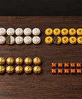 Pu-Erh Discovery Box: 10 Sticky Rice mini teas, 10 Honey Ban Zhang mini teas, 10 Jin ke portions and 10 Shazhi extract portions; one white and one yellow mini tea shown half unwrapped